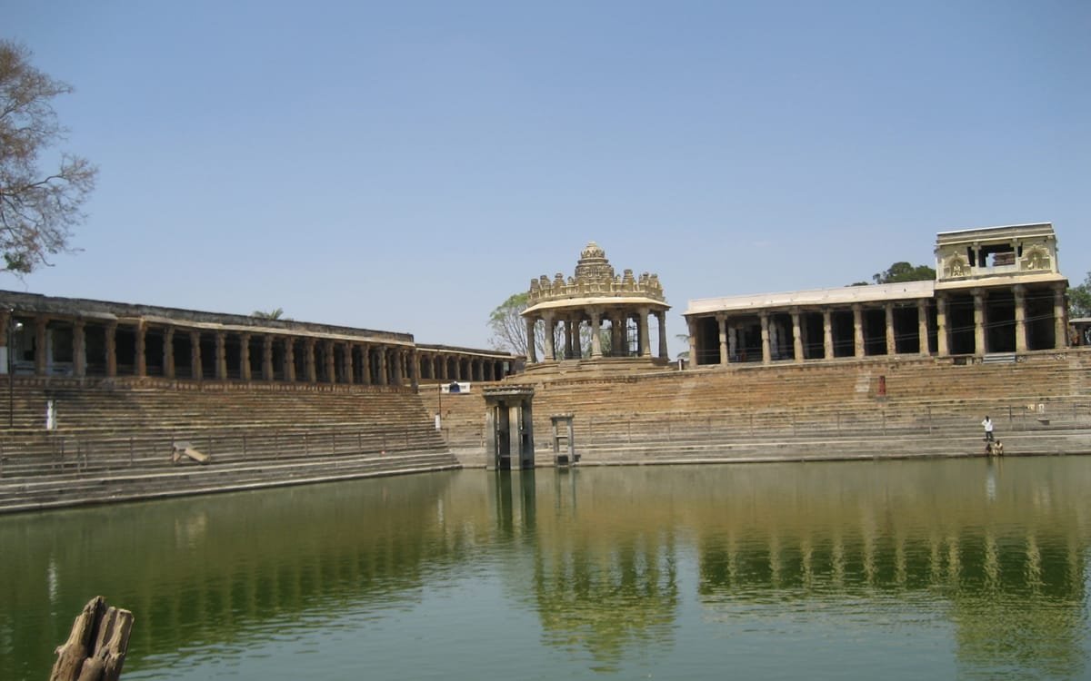 The kalyani at Melukote, its green water held in broad stone steps with a long pillared colonnade running the length of the far side.